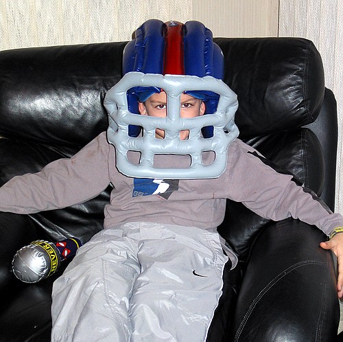 Joe tries on his Giant's football helmet