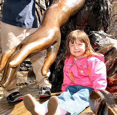 Jay smiles on the Alice statue in Central Park