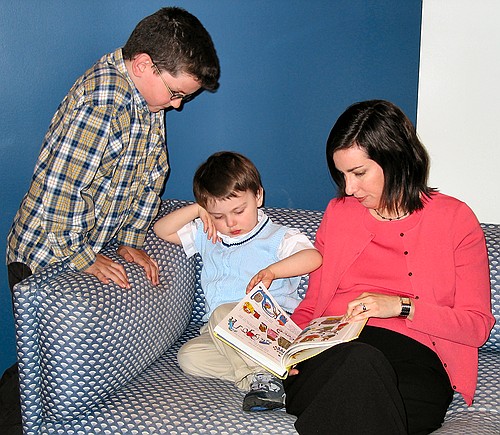 Lauren reads to Ethan while Joseph watches on