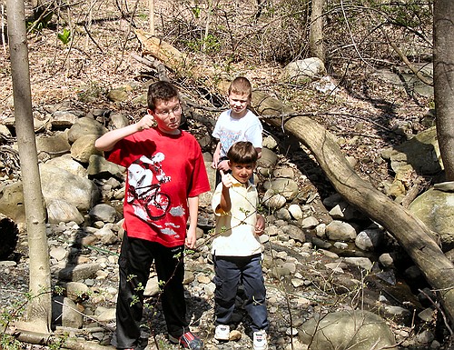 Joe, Jennifer and Jennifer exlore in the woods