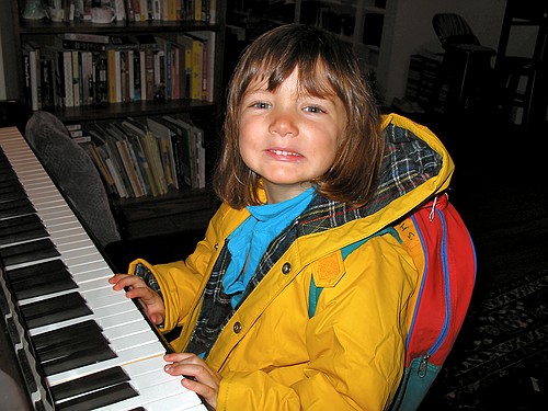 Jay smiles while "playing" the piano