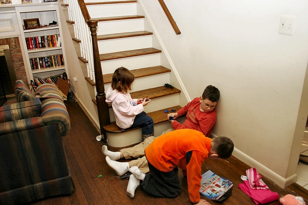 The kids play at the bottom of the stairs