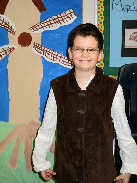 Joe poses in from of the 5th grade New Amsterdam exhibit