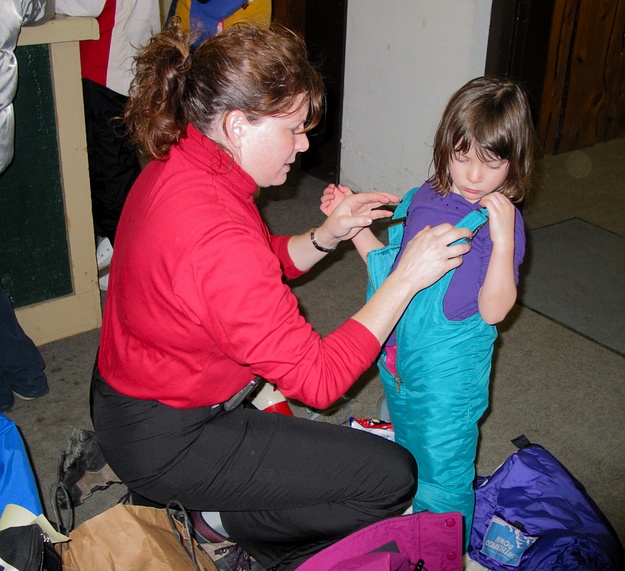 Linda helps Jay get ready to ski