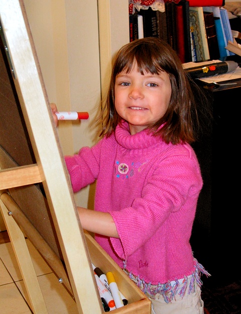 Jay draws on her birthday easel