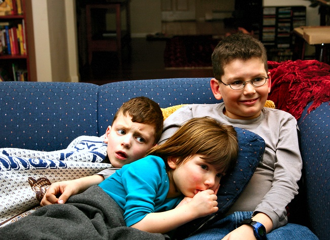 The kids rest in front of the TV