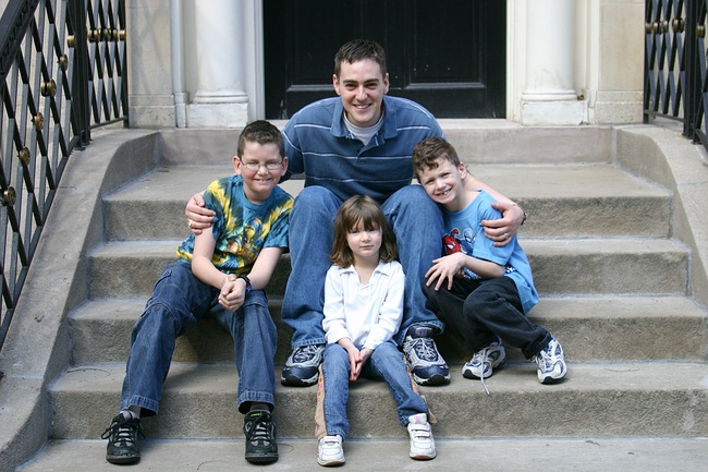 Uncle Steve poses on a stoop with the kids