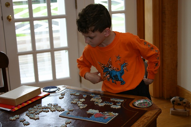 Jennifer works on the puzzle with the world's smallest piece